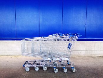 Shopping carts against blue wall