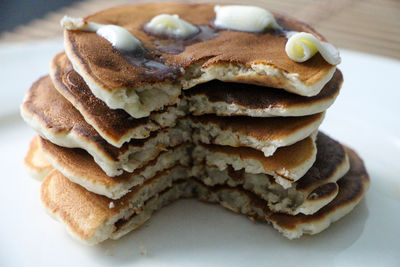 Close-up of pancakes in plate on table