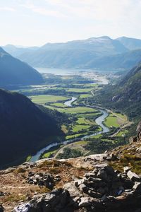 High angle view of river amidst mountains against sky