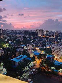 High angle view of illuminated buildings against sky during sunset