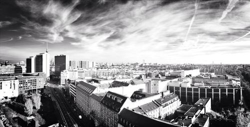 Buildings against cloudy sky