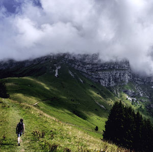 Scenic view of grassy field against cloudy sky