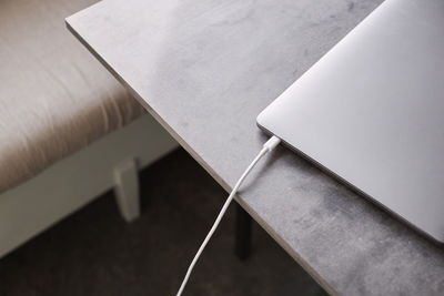 Close-up of laptop with plugged cable