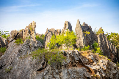 Rock formation on mountain against sky