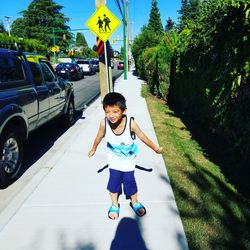 Full length of boy wearing sunglasses on road