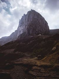 Low angle view of rock formation against sky