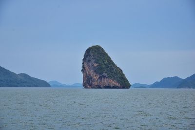 Rock formations in sea against sky