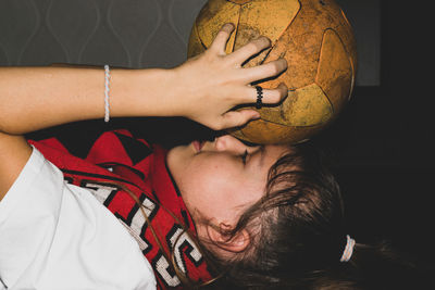 Girl fan licks with a ball on her head.