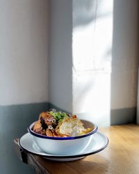 Close-up of food served on table against wall