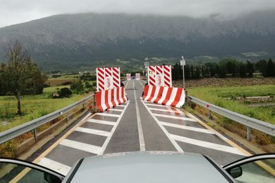 Flags on road against mountains