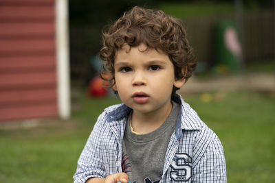 Portrait of cute boy in back yard