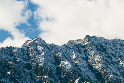 Low angle view of rocky mountains against sky