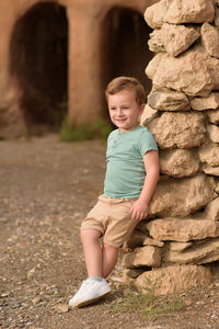 Portrait of cute boy standing on field