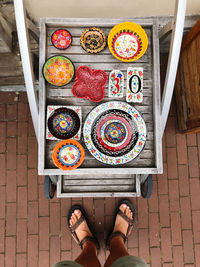 Low section of man standing by souvenirs 