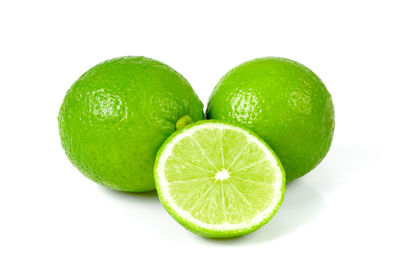 Close-up of green fruit against white background