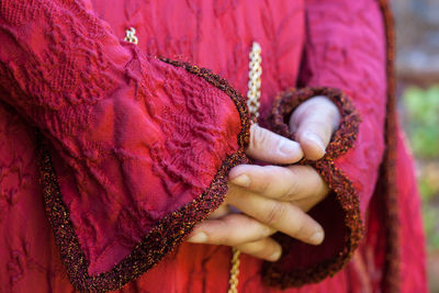 Close-up of woman hand holding pink flower