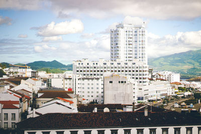 Buildings in city against sky