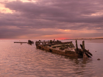 Sunrise with a sunken shipwreck from world war ii close to the beach