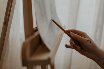 Close-up of woman painting, drawing with a pencil, artist