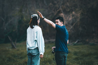 Friends standing on field