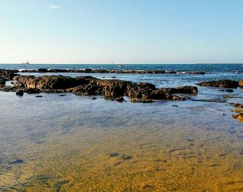 Scenic view of sea against clear blue sky