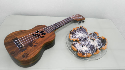 High angle view of guitar on table