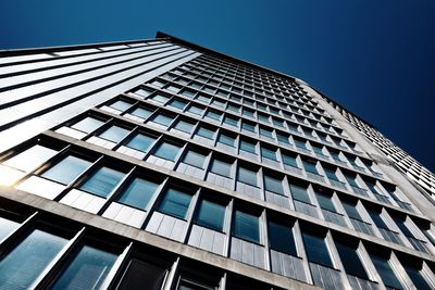 Low angle view of modern building against clear blue sky