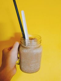 Close-up of hand holding drink