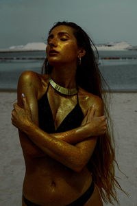 Seductive woman standing at beach