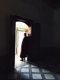 Full length of woman standing on railing