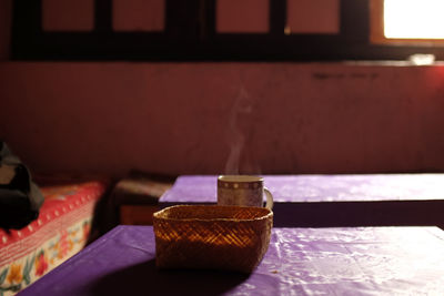 Coffee cup and basket on table