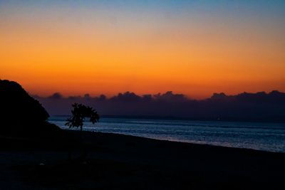 Scenic view of sea against romantic sky at sunset