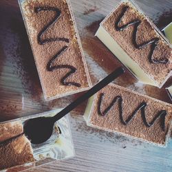 Directly above shot of tiramisu in plastic containers on table