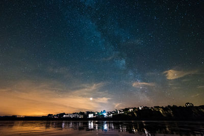 Scenic view of lake against sky at night