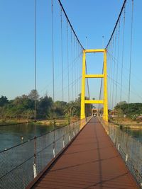 View of suspension bridge against clear blue sky