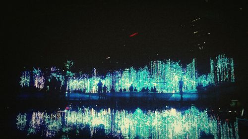 Reflection of illuminated lights in puddle