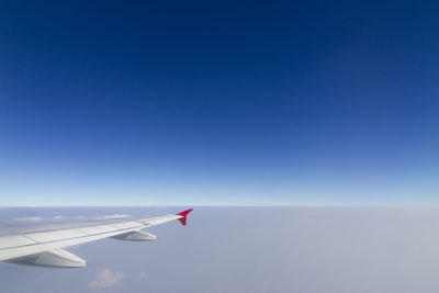 Airplane flying against clear blue sky