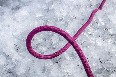 High angle view of pink rope on ice