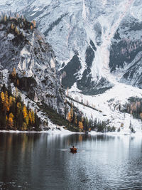 Scenic view of lake against mountains during winter