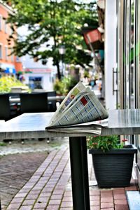 Close-up of table and tables in city