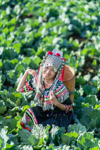 High angle portrait of woman in traditional clothing amidst farm