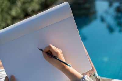 High angle view of woman drawing on easel