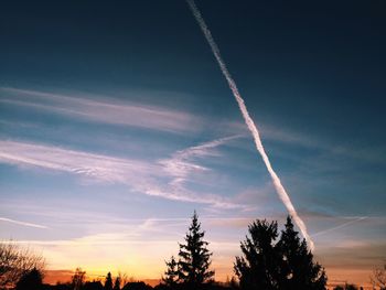 Low angle view of vapor trail against blue sky