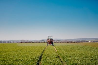 Scenic view of agricultural field against clear sky