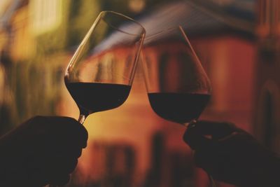 Close-up of hands holding wineglass