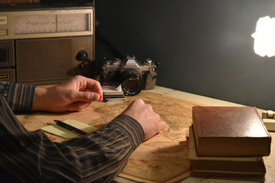 Vintage workspace with books, camera, radio and world map