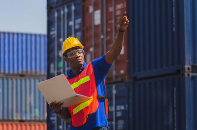 Man working against built structure