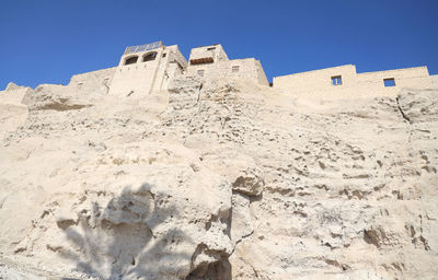 Low angle view of building against clear blue sky