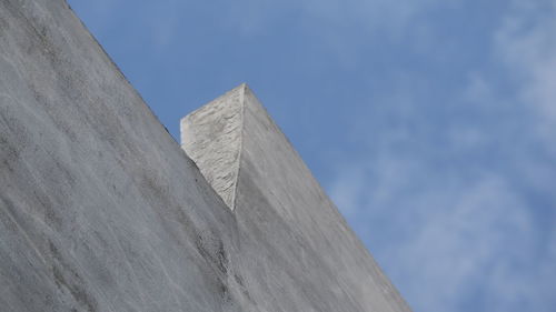 Low angle view of building against cloudy sky