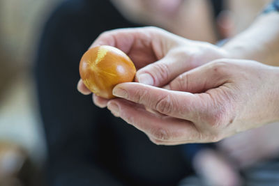Cropped hands holding egg